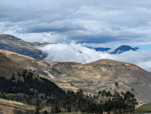 Andean fields with mountains and clouds